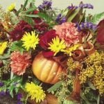 pumpkin covered with fall flowers