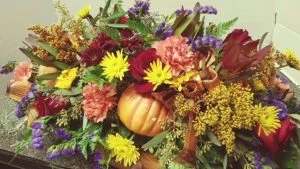 pumpkin covered with fall flowers