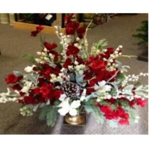 red and white flower centerpiece sitting on a table